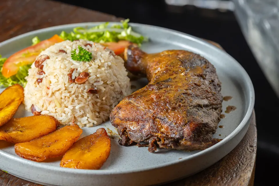 Jerk Chicken leg and thigh with rice and peas and sweet plantain